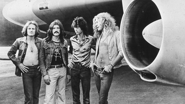 British rock band Led Zeppelin, (left - right): John Paul Jones, John Bonham (1948 - 1980), Jimmy Page and Robert Plant, pose in front of an their private airliner The Starship, 1973. (Photo by Hulton Archive/Getty Images)