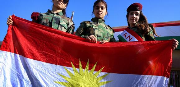 Iraqi Kurdish girls carry a Kurdistan flag during the celebration of Flag Day in the northern city of Arbil, the capital of the autonomous Kurdish region in northern Iraq, on December 17, 2014. Six months into the jihadist offensive in Iraq, the autonomous Kurds said this month they had lost more than 700 fighters and argued the burden of hosting a million displaced civilians was becoming unsustainable. AFP PHOTO / SAFIN HAMED
